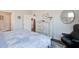 Cozy bedroom with soft blue duvet, dresser with decor, a mirror, and black leather chair at 832 Descartes St, Summerville, SC 29486