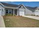Charming gray home with a well-maintained lawn, front porch, and an attached garage at 832 Descartes St, Summerville, SC 29486