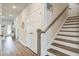 Hallway features hard wood floors, a closet, and staircase to the second floor at 832 Descartes St, Summerville, SC 29486