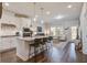 Open-concept kitchen and living room boasting stainless appliances, an island, and hardwood floors at 832 Descartes St, Summerville, SC 29486
