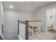 Landing area with table, two chairs, railing, and doorway to a bright bathroom at 832 Descartes St, Summerville, SC 29486