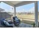 Cozy screened-in porch with wicker chairs overlooking a pond at 832 Descartes St, Summerville, SC 29486