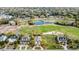 Aerial shot of upscale homes with golf course frontage, lush landscaping, and community pond at 9 Intracoastal Ct, Isle of Palms, SC 29451