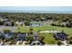Stunning aerial view of a neighborhood with a golf course, a pond, and picturesque homes at 9 Intracoastal Ct, Isle of Palms, SC 29451
