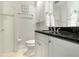 Bathroom with dark marble countertop, white cabinets, and clean white walls at 9 Intracoastal Ct, Isle of Palms, SC 29451