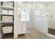 Bathroom features a shower with subway tile, a vanity, and storage shelves with towels at 9 Intracoastal Ct, Isle of Palms, SC 29451