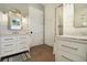 Bright bathroom featuring dual vanities, marble countertops, and a glass-enclosed shower at 9 Intracoastal Ct, Isle of Palms, SC 29451