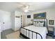 A modern bedroom with black metal frame bed, area rug, and art on the wall at 9 Intracoastal Ct, Isle of Palms, SC 29451