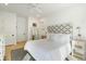 Spacious bedroom featuring a patterned headboard, natural light, and hardwood floors at 9 Intracoastal Ct, Isle of Palms, SC 29451