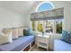 This bedroom features bench seating in the window, storage, and shiplap walls at 9 Intracoastal Ct, Isle of Palms, SC 29451