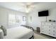 Bright bedroom with large windows, a white dresser, and black metal frame bed at 9 Intracoastal Ct, Isle of Palms, SC 29451