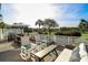 Deck featuring outdoor furniture and a grill overlooks scenic golf course views, perfect for leisure and enjoyment at 9 Intracoastal Ct, Isle of Palms, SC 29451