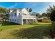Well-manicured lawn and a spacious deck offers a serene outdoor lifestyle to enjoy at 9 Intracoastal Ct, Isle of Palms, SC 29451