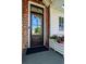 Inviting front door with unique siding details and a charming flower planter at 9 Intracoastal Ct, Isle of Palms, SC 29451