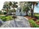 Elegant home showcasing a circular driveway, lush landscaping, and classic architectural details at 9 Intracoastal Ct, Isle of Palms, SC 29451