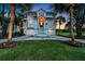 This two-story home features twin garage doors, a front porch, and manicured landscaping at 9 Intracoastal Ct, Isle of Palms, SC 29451