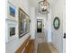 Inviting hallway with artwork, a rustic bench, and modern lighting at 9 Intracoastal Ct, Isle of Palms, SC 29451