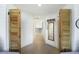 Hallway featuring shiplap, shutter doors, and access to other rooms in the home at 9 Intracoastal Ct, Isle of Palms, SC 29451