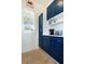 Kitchen features custom blue cabinets and shelves with stylish appliances near a window at 9 Intracoastal Ct, Isle of Palms, SC 29451