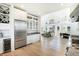 Open kitchen with stainless steel appliances, wine fridge, and view to the living area at 9 Intracoastal Ct, Isle of Palms, SC 29451