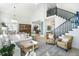 Cozy living room with neutral tones, comfortable seating, and a staircase leading to the second floor at 9 Intracoastal Ct, Isle of Palms, SC 29451