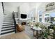 Inviting living room with fireplace, vaulted ceilings, and abundant natural light from large windows at 9 Intracoastal Ct, Isle of Palms, SC 29451