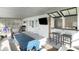 Covered porch with cozy seating, grill, and bar area is perfect for outdoor entertaining and leisure at 9 Intracoastal Ct, Isle of Palms, SC 29451