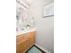 Charming half-bathroom with a wood vanity, and decorative mirror and artwork at 9118 Maple Grove Dr, Summerville, SC 29485