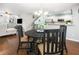 Open-concept dining room with stylish lighting and hardwood floors that connects the kitchen and living room at 9118 Maple Grove Dr, Summerville, SC 29485