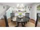 Charming dining room featuring a decorative chandelier, hardwood floors and adjacent kitchen with stainless appliances at 9118 Maple Grove Dr, Summerville, SC 29485