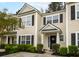 Charming townhome with neutral siding, black shutters, well-maintained landscaping, and a welcoming front entrance at 9118 Maple Grove Dr, Summerville, SC 29485