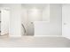 Bright hallway with carpeted floors and white trim, leading to a stairway at 9118 Maple Grove Dr, Summerville, SC 29485