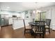 Bright eat-in kitchen with stainless steel appliances, white cabinetry, and a view to the dining room at 9118 Maple Grove Dr, Summerville, SC 29485