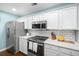 Well-lit kitchen with stainless steel appliances, white cabinetry, and plenty of counter space for cooking at 9118 Maple Grove Dr, Summerville, SC 29485