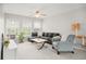 Cozy living room with natural light, a ceiling fan, and comfortable seating at 9118 Maple Grove Dr, Summerville, SC 29485