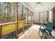 Cozy screened porch with a view of the wooded backyard, offering a peaceful outdoor living space at 9118 Maple Grove Dr, Summerville, SC 29485