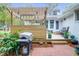 Cozy back porch featuring wood floors, an outdoor grill, and a seamless transition to the beautifully landscaped backyard at 935 Lansing Dr, Mount Pleasant, SC 29464