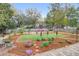 Lush backyard featuring a well-maintained lawn, flower beds, and a tranquil seating area for enjoying the outdoors at 935 Lansing Dr, Mount Pleasant, SC 29464