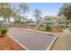 Large backyard gravel bocce ball court with wooden perimeters and small garden. Backyard view of home at 935 Lansing Dr, Mount Pleasant, SC 29464