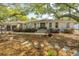 Inviting home with a charming facade, showcasing mature trees and green lawn at 935 Lansing Dr, Mount Pleasant, SC 29464