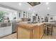 Well-lit kitchen with stainless steel appliances, white cabinetry, and an island with wood and granite accents at 935 Lansing Dr, Mount Pleasant, SC 29464