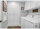 Laundry room with white appliances, custom cabinets, and ample storage at 935 Lansing Dr, Mount Pleasant, SC 29464
