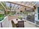 Inviting outdoor seating area featuring a pergola, built-in bench, and a comfortable dining set. Perfect for relaxation and entertaining at 935 Lansing Dr, Mount Pleasant, SC 29464