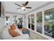 Sunroom with sliding glass doors opening to a deck, white sofa, and stylish décor at 935 Lansing Dr, Mount Pleasant, SC 29464