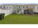 A spacious fenced backyard with a patio area and green grass at 9727 Transplanter Cir, Ladson, SC 29456