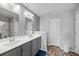 Bathroom featuring double sinks, gray cabinets, and wood-look flooring at 9727 Transplanter Cir, Ladson, SC 29456
