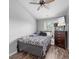 Bedroom featuring black and white bedsheets, wood-look flooring, and a TV at 9727 Transplanter Cir, Ladson, SC 29456