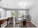 Bright dining area featuring a glass table, stylish chairs, and a modern chandelier at 9727 Transplanter Cir, Ladson, SC 29456