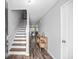 Inviting entryway with stylish wood floors leading to the living areas, stairs, and kitchen at 9727 Transplanter Cir, Ladson, SC 29456