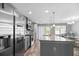 Modern kitchen with stainless steel appliances, a large island, and a view into the dining area at 9727 Transplanter Cir, Ladson, SC 29456